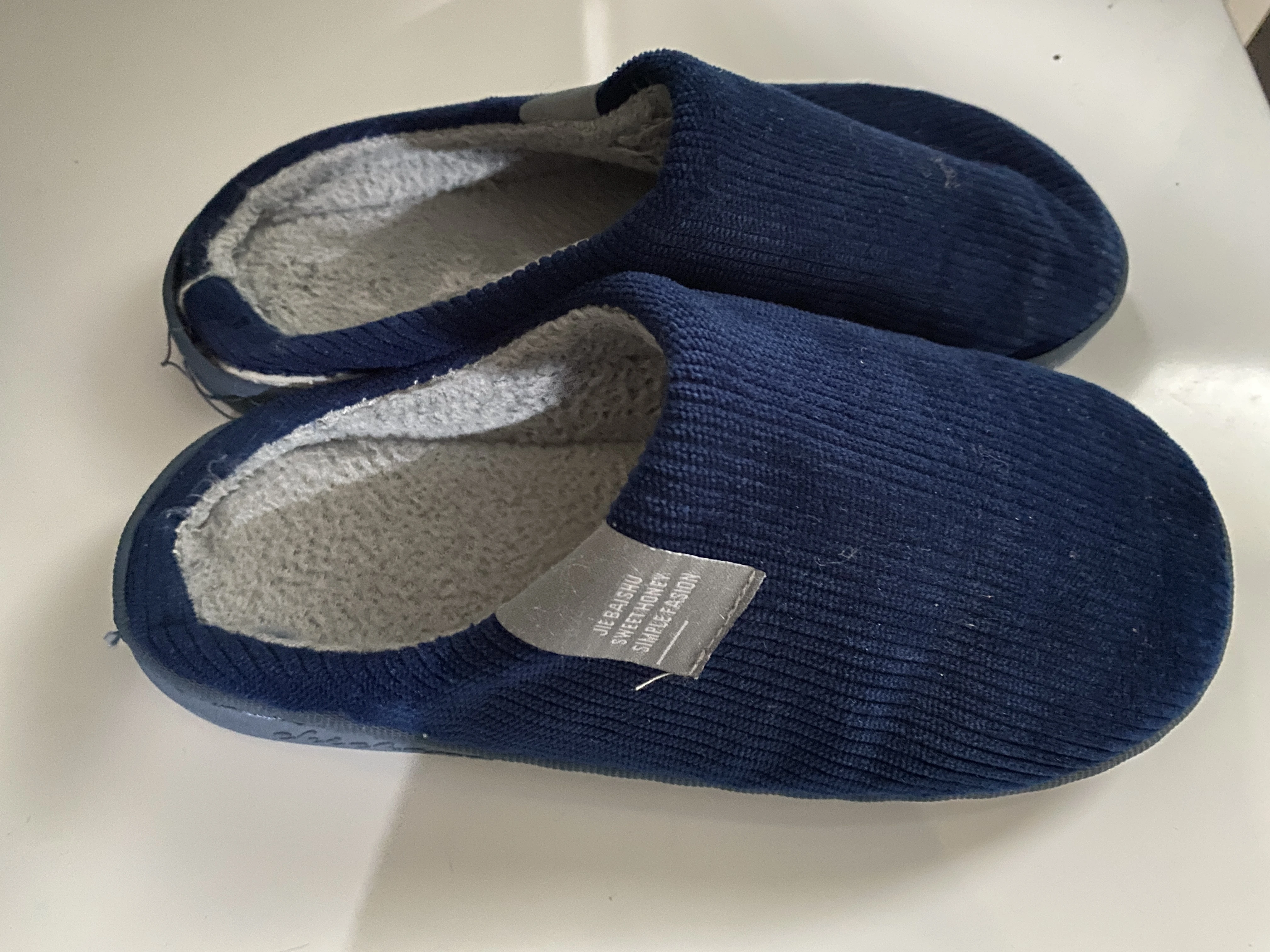 Instantly created AI lifestyle photo of a man with the slippers on display (AI)
